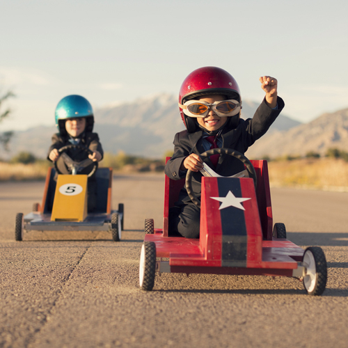 Young Business Boys in Suits Race Toy Cars